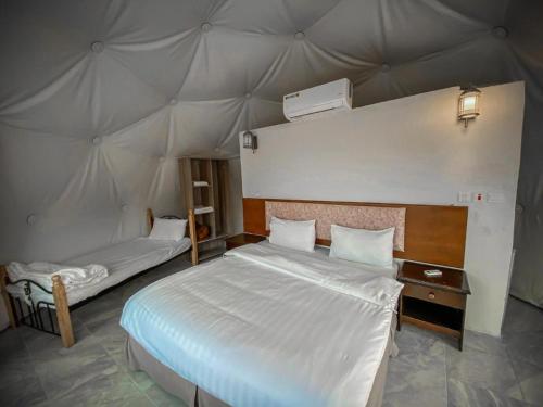a bedroom with two beds in a tent at Wadi Rum Aviva camp in Wadi Rum