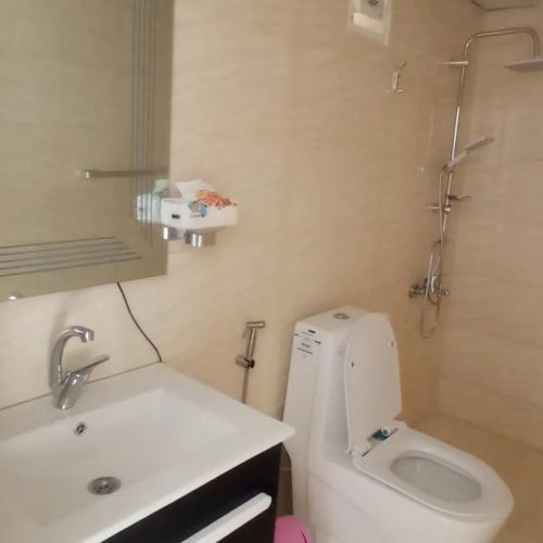 a bathroom with a white toilet and a sink at Wadi Rum Aviva camp in Wadi Rum