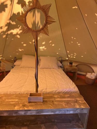a bed in a tent with a mirror on it at Camping Paxariñas in Portonovo