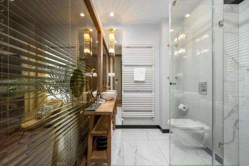 a bathroom with a toilet and a sink and a shower at Sava Boutique Hotel in Warsaw
