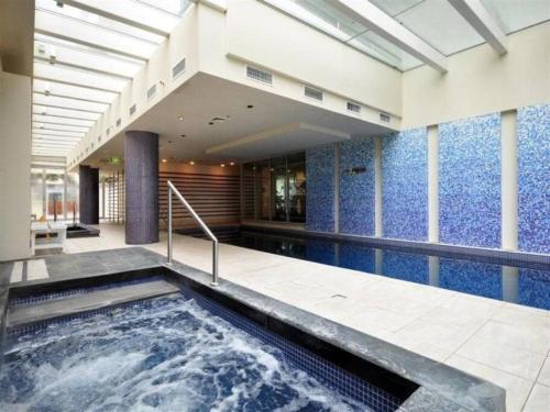 a hot tub in a building with blue walls at Liberty bay holiday Spacious two bedroom, two bathroom with sea views in Glenelg