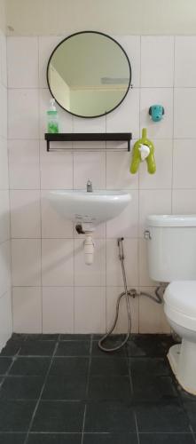 a bathroom with a sink and a mirror and a toilet at NBH.@ Prannok in Bangkok