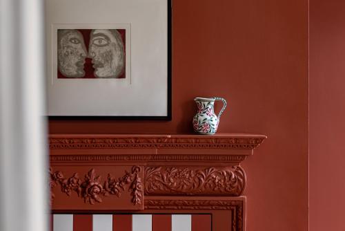 a vase sitting on top of a mantle in a room at Cowley Manor Experimental in Cheltenham
