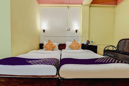 two beds sitting next to each other in a room at SPOT ON Durba 2 in Tezpur