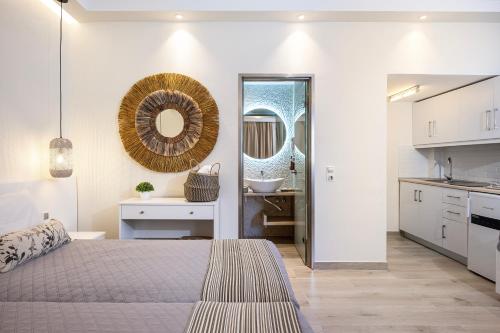 a bedroom with a bed and a sink and a mirror at Panorama Seaside in Mastichari