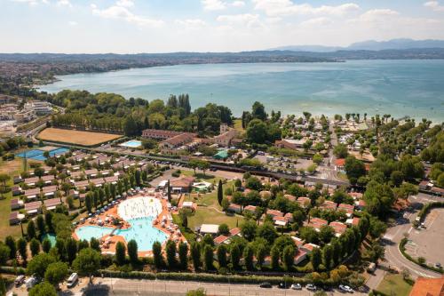 an aerial view of a resort with a lake at San Francesco Camping Village in Desenzano del Garda
