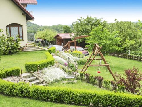 a garden with a swing set in the yard at Delightful Holiday Home in Lubin with Garden in Międzyzdroje