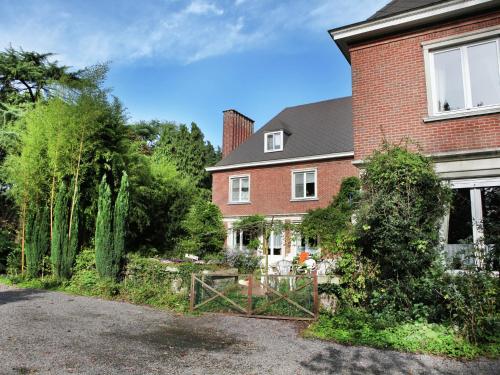 a brick house with a gate in front of it at Comfortable Mansion in Doomkerke near Forest in Ruiselede