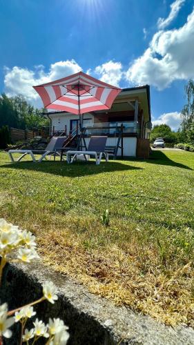 a house with a picnic table and an umbrella at Lipno Villa Beach - Lipno Stausee - Lakeside in Loučovice