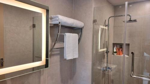 a bathroom with a shower and a mirror at Bo304-Panorama Seaview 1 Bedroom at Ao Nang Beach in Ao Nang Beach