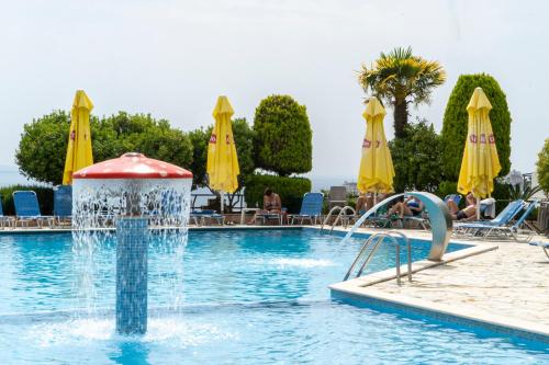 a swimming pool with a fountain in a resort at Hotel Mediterrane in Sarandë