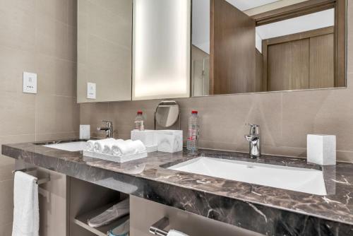 a bathroom with two sinks and a mirror at BLVD SkyView in Dubai