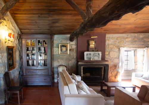 a living room with a couch and a fireplace at Quinta da Graca- Complexo Turistico in Resende