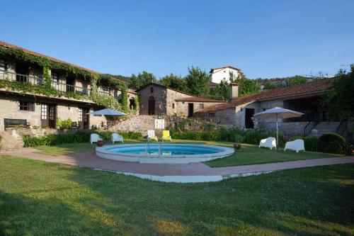 a swimming pool in the middle of a yard at Quinta da Graca- Complexo Turistico in Resende