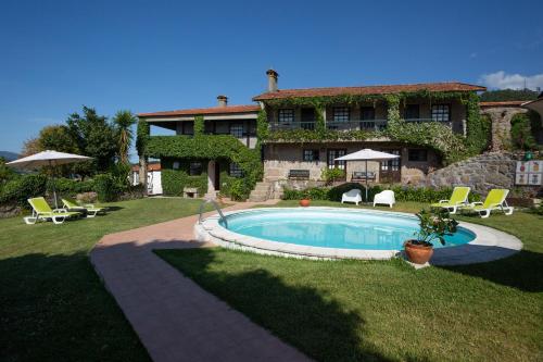 a house with a swimming pool in the yard at Quinta da Graca- Complexo Turistico in Resende