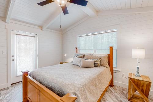 a bedroom with a bed and a ceiling fan at The Yellow Rose in Gulf Shores