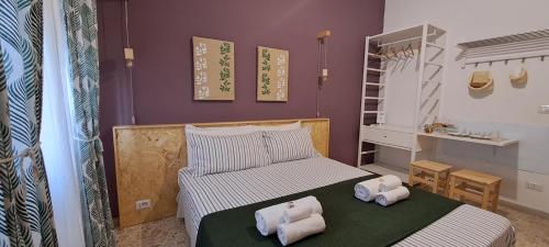 a bedroom with a bed with towels on it at Il Vaso di Creta in Ragusa