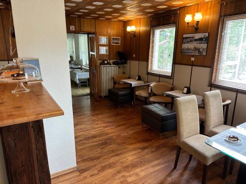 a restaurant with tables and chairs in a room at Domki Zdrojowe in Polanica-Zdrój