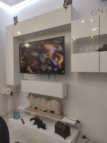 a living room with a television on a wall at Gold Infinity in Velingrad