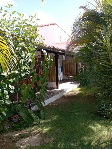 a view of a house from the garden at Pousada Casa Do Cocotier in São Miguel do Gostoso