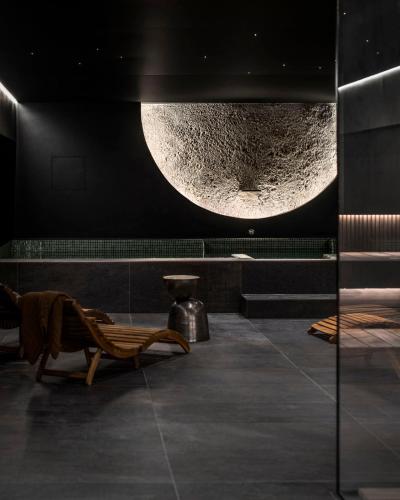 a room with a bench and a moon on the wall at Monist Palanga boutique by SPA VILNIUS in Palanga