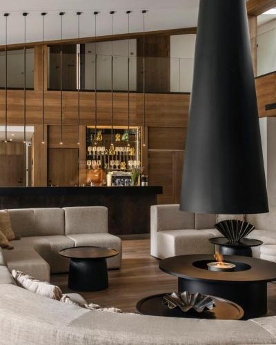 a living room with a couch and tables and a bar at Monist Palanga boutique by SPA VILNIUS in Palanga
