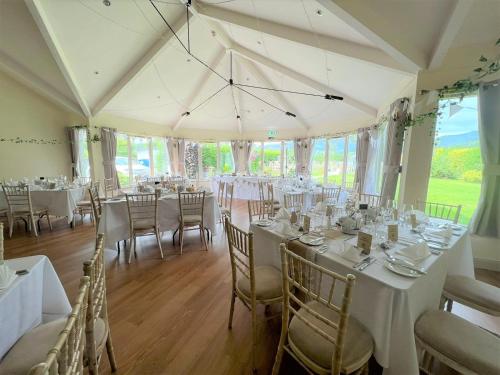 a large room with tables and chairs in it at Callander Hostel in Callander