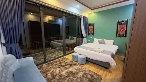 a bedroom with two beds and a large window at Sapa Eco Villas & Spa in Sa Pa