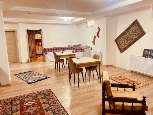 a dining room with tables and chairs in a room at Aysultan Stone House in Uchisar