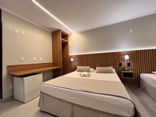 Ένα ή περισσότερα κρεβάτια σε δωμάτιο στο Hotel Bons Tempos
