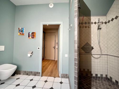 a bathroom with a toilet and a shower at Le Five Tellier - Monkey in Reims