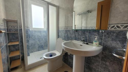 a bathroom with a sink and a toilet and a shower at Gemelos 22-Fincas Benidorm in Benidorm