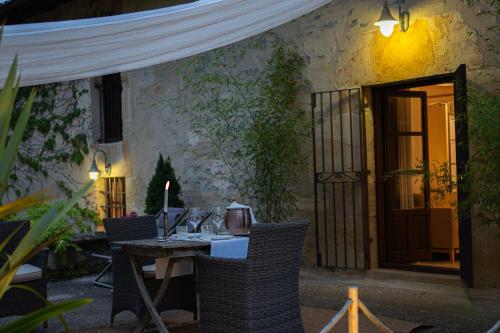 a table and chairs in front of a building at Hotel Palacio De Luko in Luco