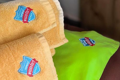 a close up of a yellow pillow with red and blue buttons at Wesendorf Residenz Premium Lounge in Wesendorf