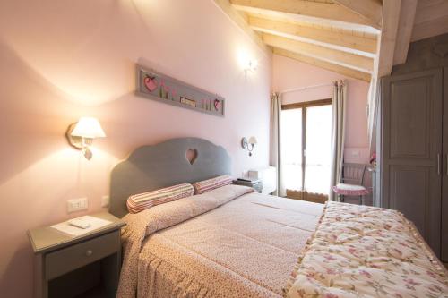 a bedroom with a large bed and a table and lamp at Locanda Zita in Sestola