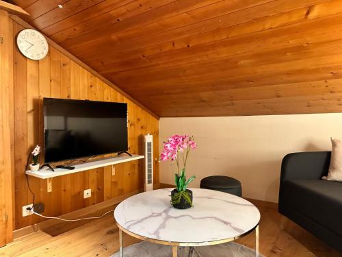 カンデルシュテークにあるAlpina Appartment 2のテーブルとテレビのあるリビングルーム