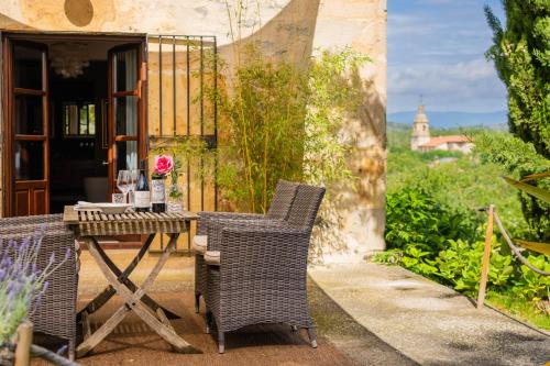 a table and chairs sitting on a patio at Hotel Palacio De Luko in Luco