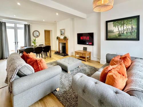 a living room with two couches and a fireplace at Rye Court Cottage and Annex Central Hemsley in Helmsley