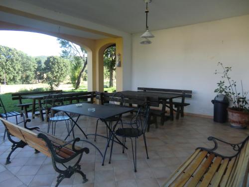 a restaurant with tables and chairs and a patio at Agriturismo Cavallin Del Bufalo in Manciano