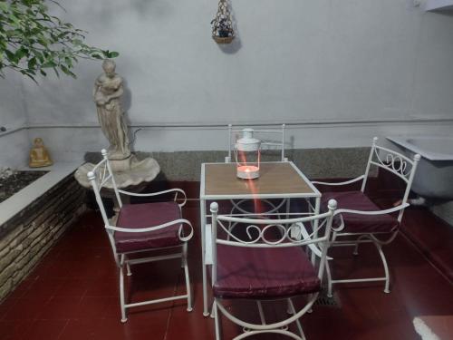 a small table with two chairs and a candle on it at CASA OLGUITA in Godoy Cruz