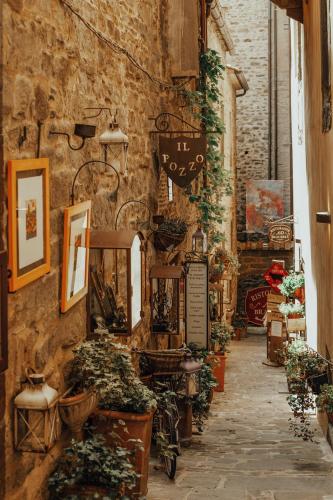 an alley in an old building with plants on the wall at Villa di Piazzano - Small Luxury Hotels of the World in Cortona