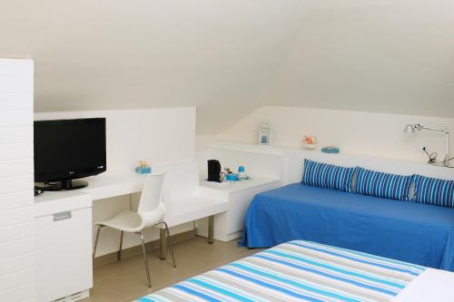 TV a/nebo společenská místnost v ubytování Albergo Punta de l'Est