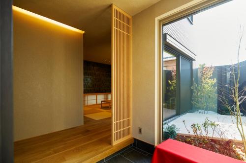 a room with a large glass door with a large window at 犬山城下町一棟貸しの宿 結美いぬやま in Inuyama