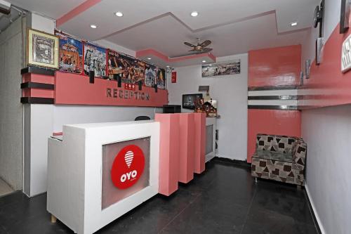 a fast food restaurant with a red and white counter at Capital O Hotel Orchid Inn in Kankhal