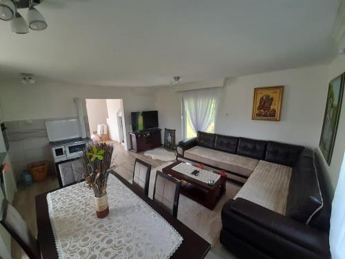 a living room with a couch and a table at Jezerina in Šavnik
