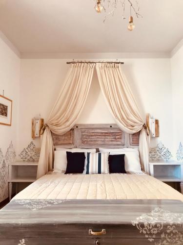 a bedroom with a large bed with a canopy at Casa Caterina Lake View Holidays Apartments in Peschiera del Garda