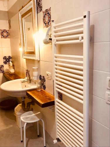 a white bathroom with a sink and a toilet at Casa Caterina Lake View Holidays Apartments in Peschiera del Garda