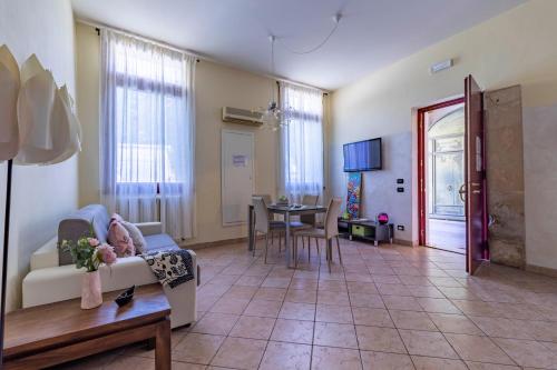 ein Wohnzimmer mit einem Sofa und einem Tisch in der Unterkunft Casa Charleston in Palazzo Nobiliare al Duomo in Padua