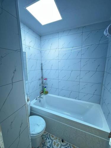 a bathroom with a white tub and a toilet at Charming nicely renovated terrace in Liverpool