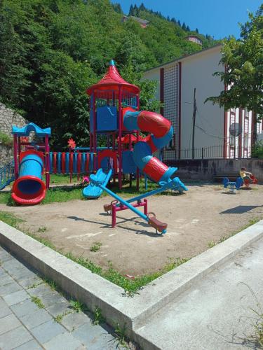 a playground with a red and blue slide at Erdoğan Konut in Çaykara